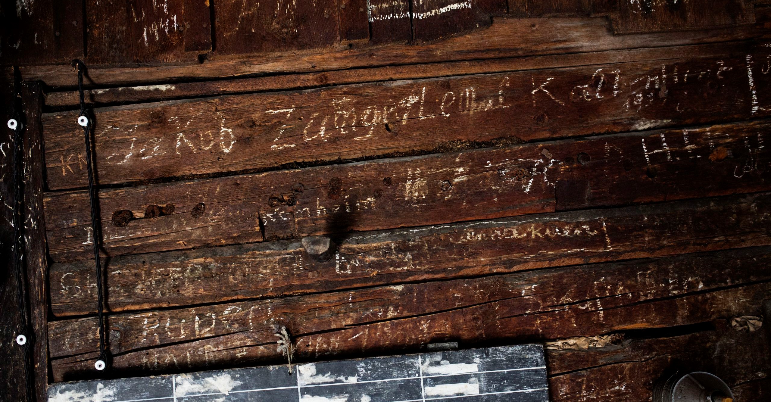 wooden wall with glyphes in it