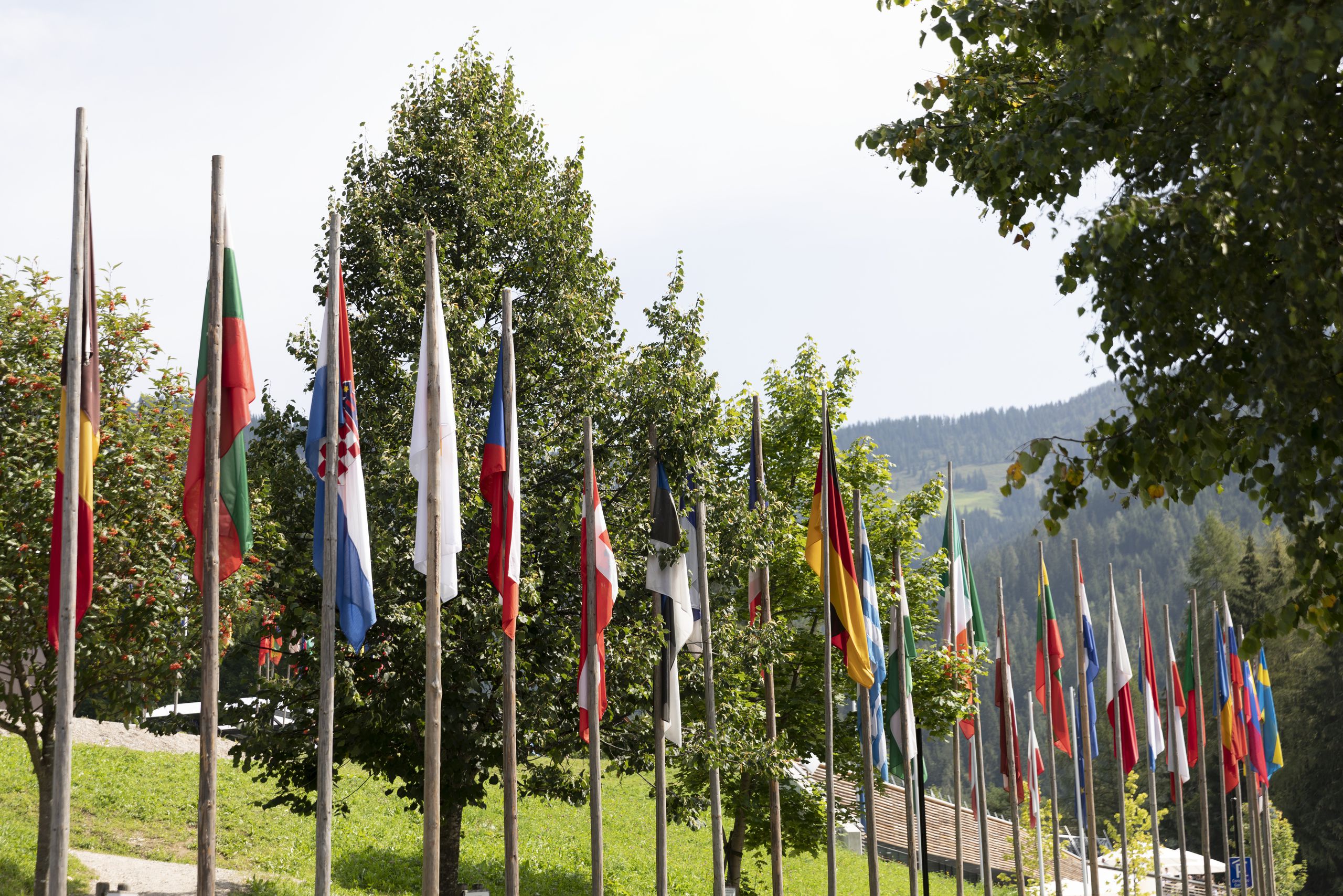 Different flags in front of the Congress Center Alpbach